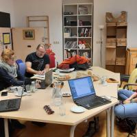image of people sitting around conference table