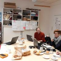 image of people sitting around conference table