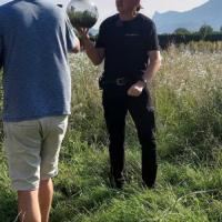 two people in nature holding a silver ball